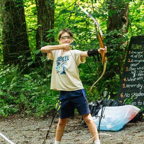 A camper practicing archery at Camp Carolina